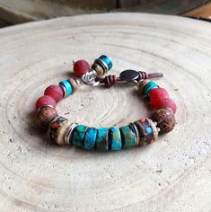 "Inspired by the gorgeous rugged red rock of the desert southwest, this chunky turquoise bracelet is perfect for her as well as for him. As a unisex piece, it's great going solo on the arm as well as joining other great-looking bracelets as a stacking bracelet. Wear it and enjoy it or gift it - she - or he - will LOVE it! Specifics - *A segment of rugged turquoise heishi beads takes center stage in this fabulous Sundance style bracelet. *Playing supporting roles, rough agate rounds, matte carnel Earthy Turquoise Bracelets For Festival, Red Bohemian Beaded Bracelets With Natural Stones, Handmade Southwestern Healing Bracelets, Southwestern Turquoise Bracelets With Polished Beads, Southwestern Style Adjustable Red Bracelets, Red Bohemian Bracelet With Natural Stones, Bohemian Red Bracelet With Natural Stones, Adjustable Red Southwestern Bracelets, Southwestern Hand-strung Beaded Bracelet For Beach