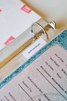 a close up of a birth certificate with a ring on it's clipboard