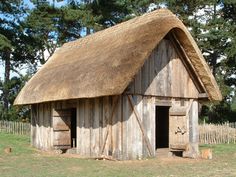 an old wooden building with a thatched roof