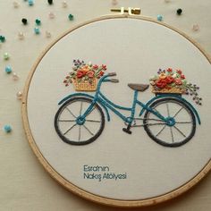 a blue bicycle with flowers in the basket on it's front and back wheel