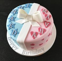 a decorated birthday cake on a black table