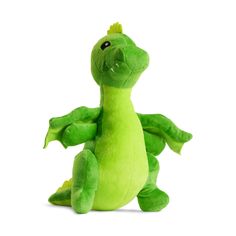 a green stuffed dragon sitting up against a white background