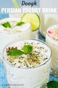 three glasses filled with yogurt and garnished with herbs