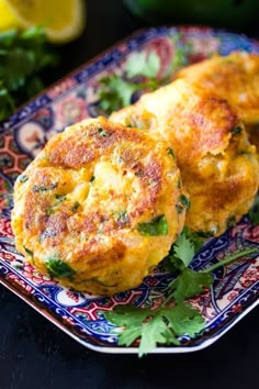 two crab cakes on a plate with parsley