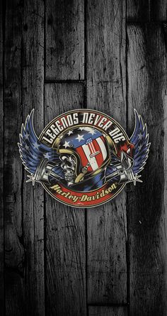 a wooden wall with an american flag and motorcycle emblem on it's back side