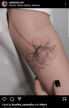 a woman's arm with a flower tattoo on the left side of her body