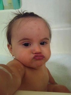 a baby is taking a bath in the tub