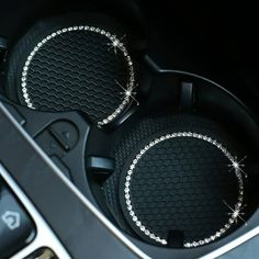 two speakers in the center console of a car with diamond trimmings on them