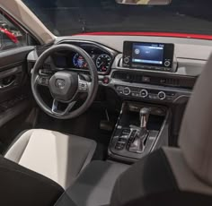 the interior of a car with dashboard, steering wheel and infotains on display