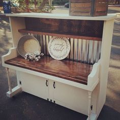 a white bench with some plates on it