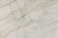 a white marble textured surface with lines and curves