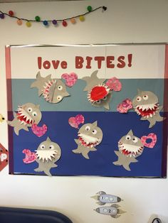 a bulletin board with paper cut out of shark's teeth and the words love bites on it