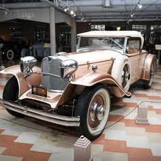 an antique car on display in a museum