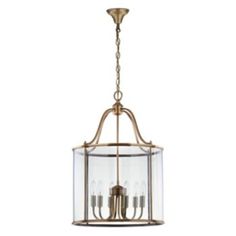 an antique brass finish chandelier with clear glass panels and four candles in the center