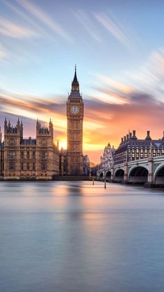 the big ben clock tower towering over the city of london, england at sunset or dawn