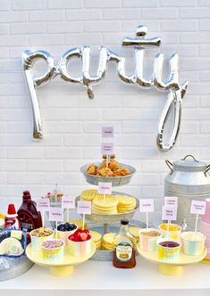 a table topped with lots of food next to a sign that says pudgy