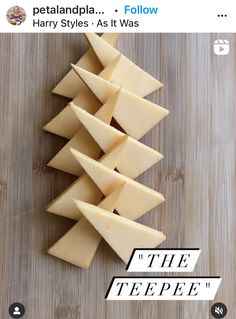 a pile of cheese sitting on top of a wooden cutting board