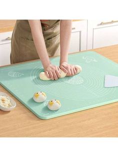 a person standing over a cutting board with eggs on it