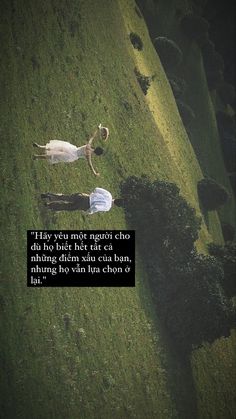 two people laying in the grass with a quote