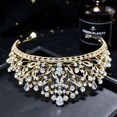 Up your sparkle factor with this romantic tiara design that can complete the most sophisticated of bridal looks. Intricately faceted cubic zirconia work their way across the band and capture the light from every angle with a perfectly translucent appeal. Cast in lightweight alloy and silver/yellow gold/rose gold plated for a flawless finish, the headband measures 2.5" at the tallest point (approx. 6.3cm) and 6" in diameter (approx. 15cm). Two small loops at each end make it easy to attach to you Wedding Crown With Rhinestones And Pinched Shape, Wedding Teardrop Crown Headpiece, Cubic Zirconia Bridal Necklace For Wedding, Teardrop Crown Jewelry With Rhinestones For Wedding, Wedding Bridal Necklace With Cubic Zirconia, Teardrop Crown Headpiece With Rhinestones For Wedding, Wedding Teardrop Crown Headpiece With Rhinestones, Wedding Headpiece With Rhinestones And Round Crown, Luxury Wedding Crown Jewelry