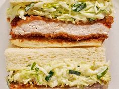 two sandwiches are stacked on top of each other with lettuce and meat in the middle