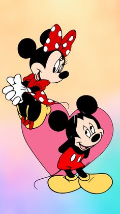 two mickey and minnie mouses are in the shape of a heart on a colorful background