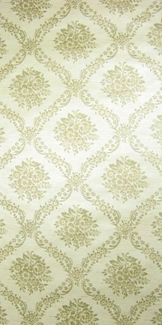 a white and gold wallpaper with an intricate design on it's surface,