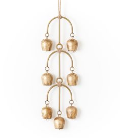 a gold hanging candle holder with five candles