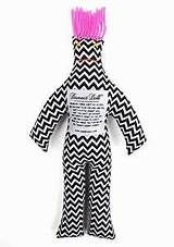 a black and white chevron doll with pink hair on it's head, standing in front of a white background