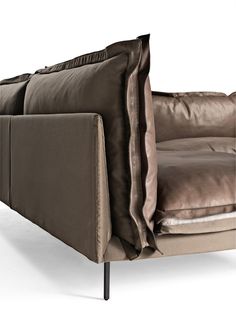 a couch with two pillows on top of it and one arm folded back to the side