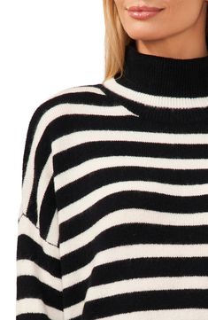 Dropped shoulders and a slouchy fit add to the cozy appeal of this smartly striped sweater knit with a warm fold-over turtleneck. 23 1/2" length (size Medium) Turtleneck Long sleeves 73% acrylic, 24% polyester, 3% spandex Hand wash, dry flat Imported Striped Turtleneck, Sweaters Knitwear, Striped Sweater, Sweater Knit, Turtleneck Sweater, Drop Shoulder, Knitted Sweaters, Knitwear, Turtle Neck