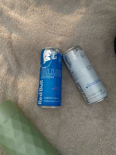 two cans of energy drink sitting on top of a towel