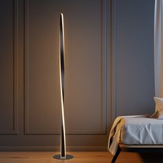 a modern floor lamp in the corner of a room with an unmade bed next to it