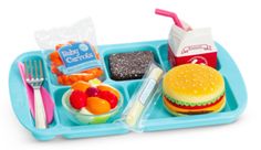 a blue tray filled with food on top of a white table next to a plastic fork and knife