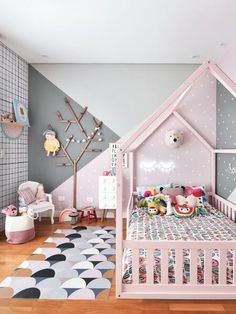 a child's bedroom decorated in pastel colors with polka dots and a pink dollhouse bed