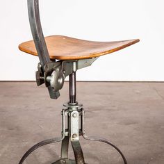 an old metal and wood desk chair with wheels