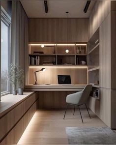 a modern home office with built - in shelving and lighting