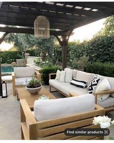 an outdoor living area with couches and tables