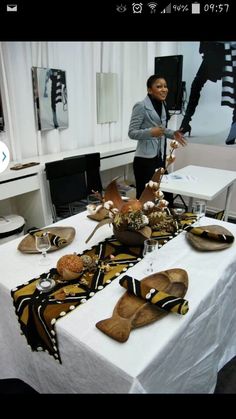 a woman standing in front of a table with shoes on it