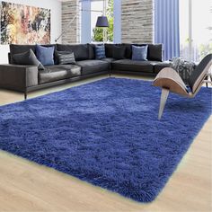 a living room with blue rugs and furniture