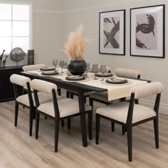 a dining room table with chairs and plates on it