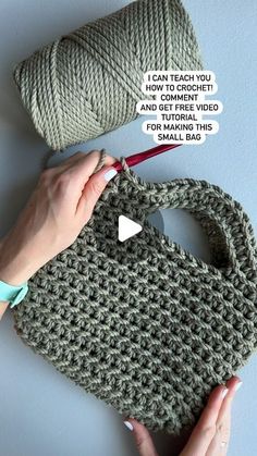 a crocheted purse being worked on by someone using a knitting needle and thread