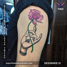 a person with a tattoo on their arm holding a flower