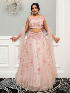 Farah Lehenga is a beautiful ensemble in an eternal blush pink, elevating the bride's attire. The scrupulous embroidery and glint of mirrors and resplendent pearls and glittering stone make it classy and sumptuous. Stitched with soft net fabric, it is inclusive of embroidered dupatta and blouse and lehenga that gives an ultimate, refined and royal look to the bride-to-be at her special occasion. Ideal for weddings and other exclusive events. Key Features: Color: Blush Pink Fabric: Soft net Embel Buy Lehenga Online, Blush Pink Fabric, Indian Bridal Couture, Elegant Veils, Reception Gowns, Bride Attire, Mehendi Outfits, Bridal Lehenga Red, Ethnic Chic