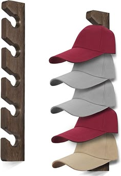 a hat rack with five hats hanging from it's sides and two wooden hooks on the wall