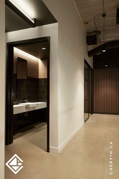 Sleek walnut slab wall, concrete bathroom vanity. Corporate Bathroom, Office Bathrooms, Concrete Vanity, Office Bathroom, Corporate Office, Modern Office, Powder Room, Modern Bathroom