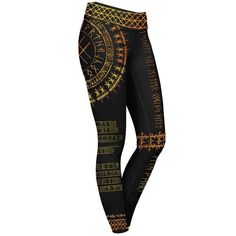 a woman's leggings with gold and black designs on it, all over