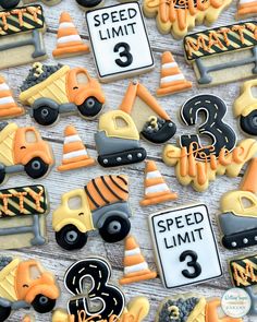 decorated cookies with construction vehicles and road signs on top of each cookie, along with the number 3