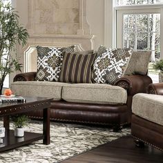 a living room with couches, chairs and a coffee table in front of a window