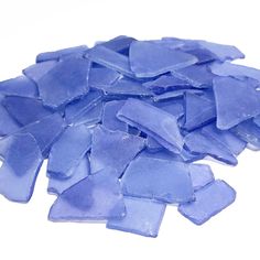 blue sea glass chips on a white background